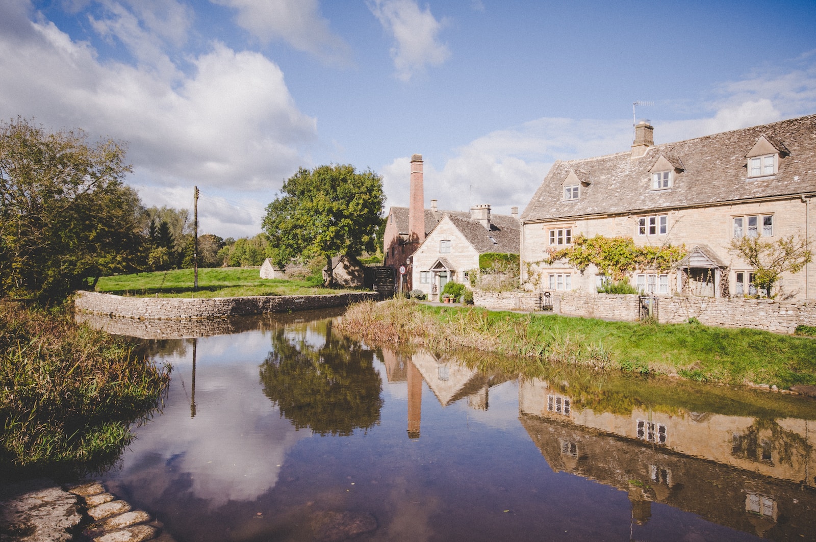 houses near pond during daytime